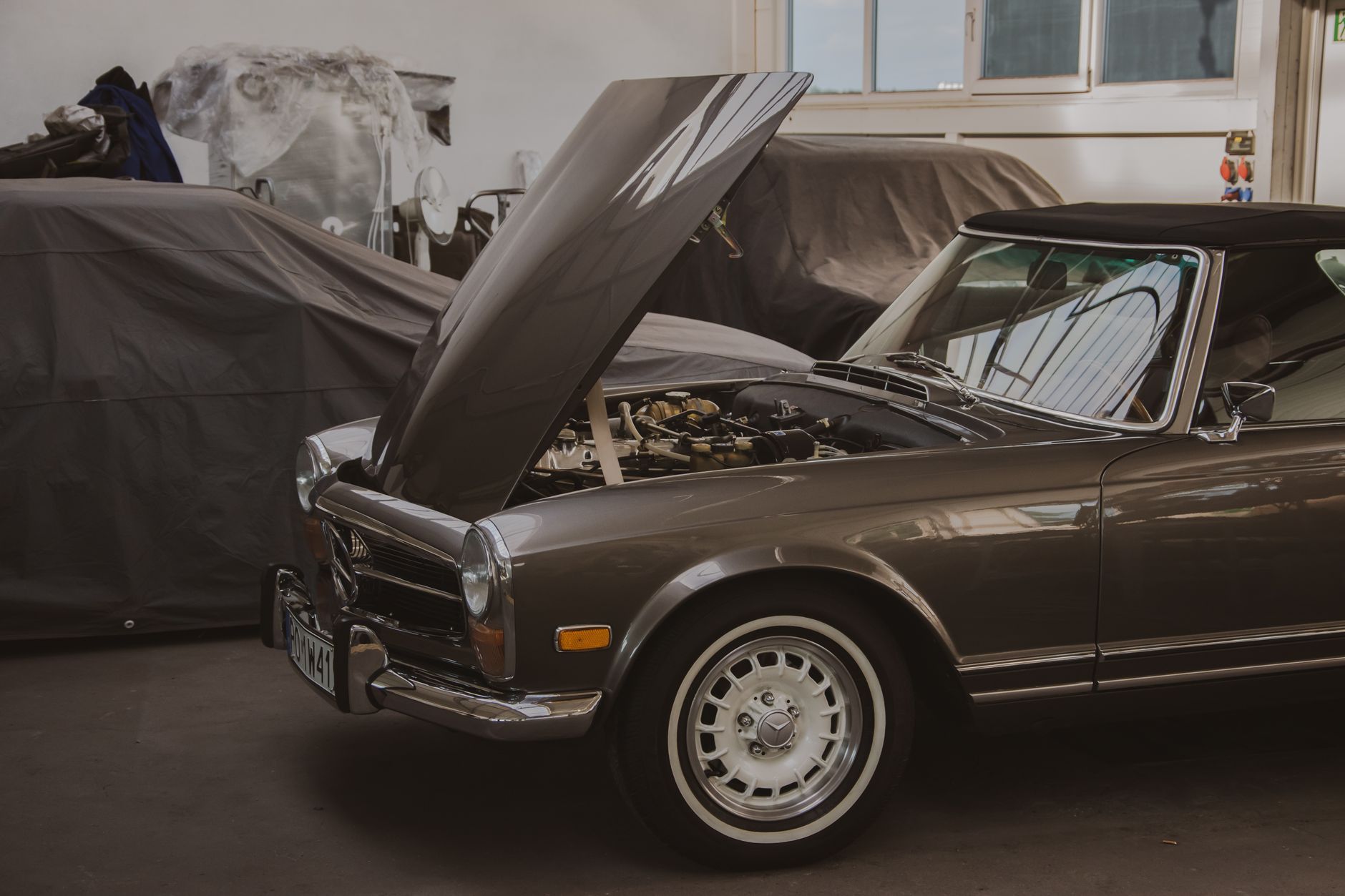 Classic Mercedes with hood open, engine visible